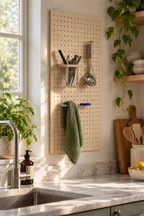 Blue coloured ring on a kitchen pegboard holding a green tea towel