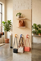 Shop pegboard with yellow, blue and orange coloured rings holding bags